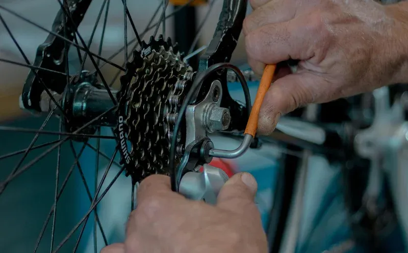 Bike repair near me on the Northshore — Brooks Bike Shop mechanic adjusting a derailleur in the Covington workshop